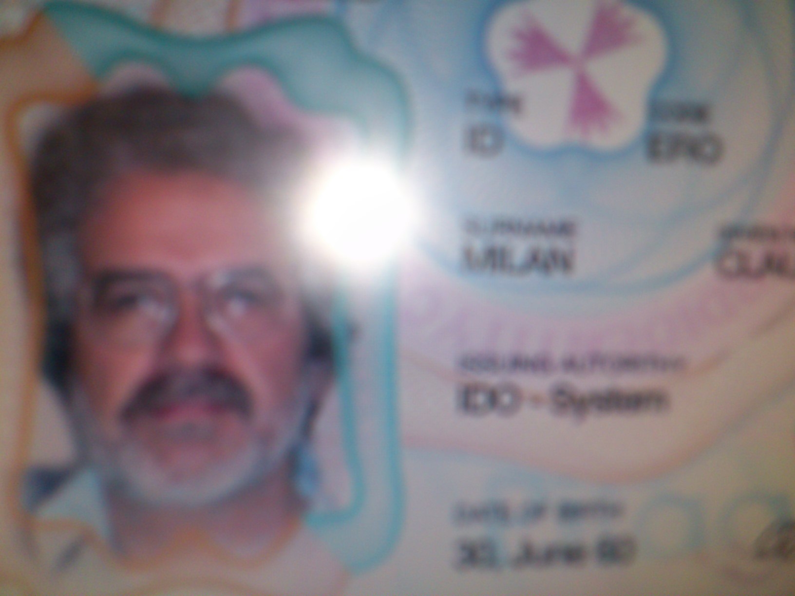 An unacceptable blurry/out of focus ID, with details masked: